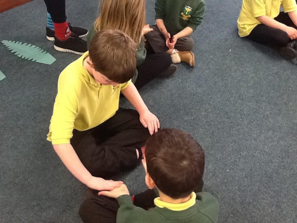 We showed care for each other by massaging a partner's hands.