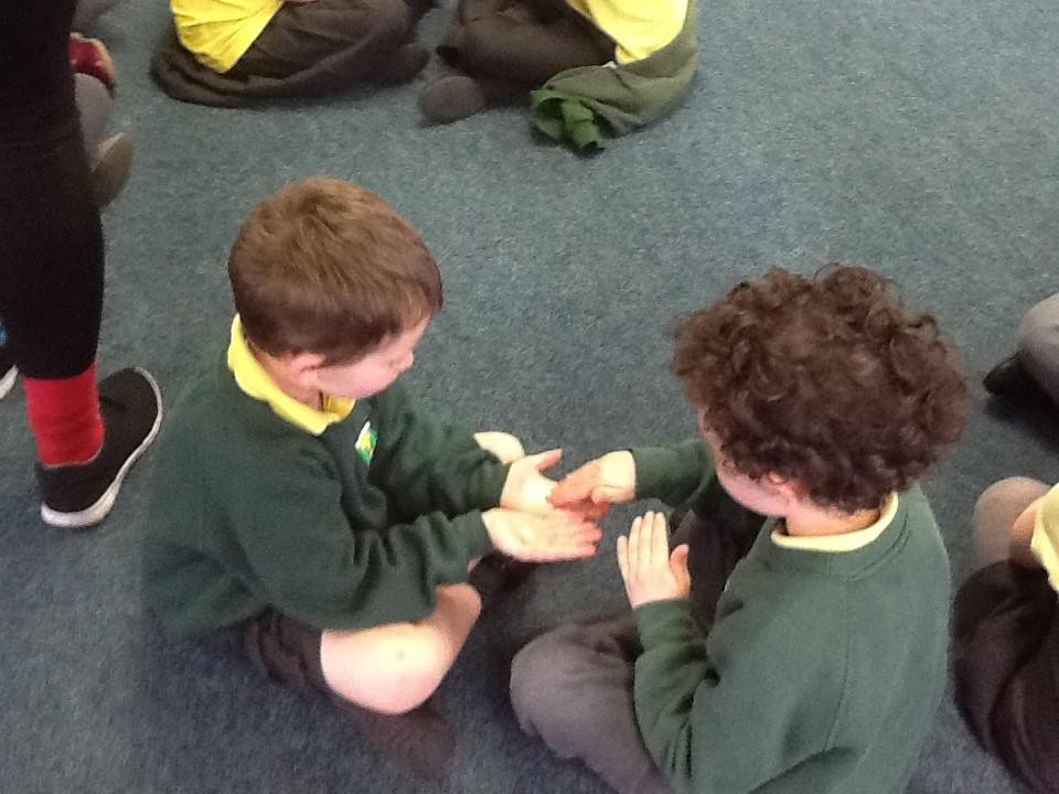 We showed care for each other by massaging a partner's hands.