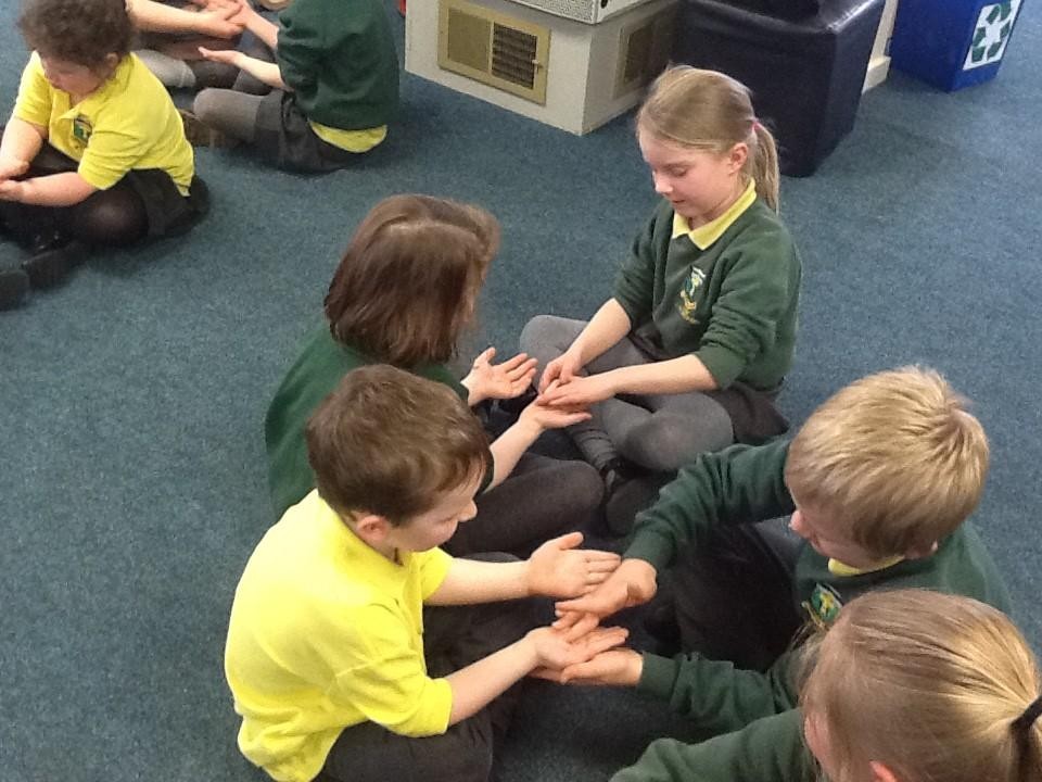 We showed care for each other by massaging a partner's hands.