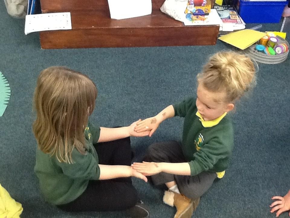 We showed care for each other by massaging a partner's hands.