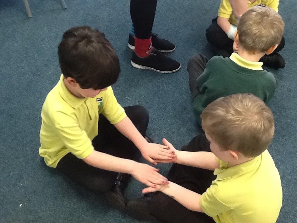 We showed care for each other by massaging a partner's hands.