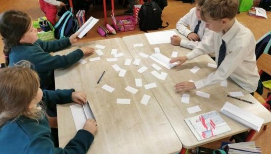 Children working at a desk together
