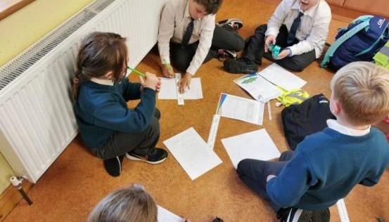Children sat together drawing 