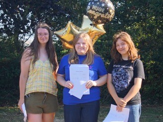 Ry Hampshire, Imogen Sayce, and Cecilia Beevers receiving their results at Helston Community College