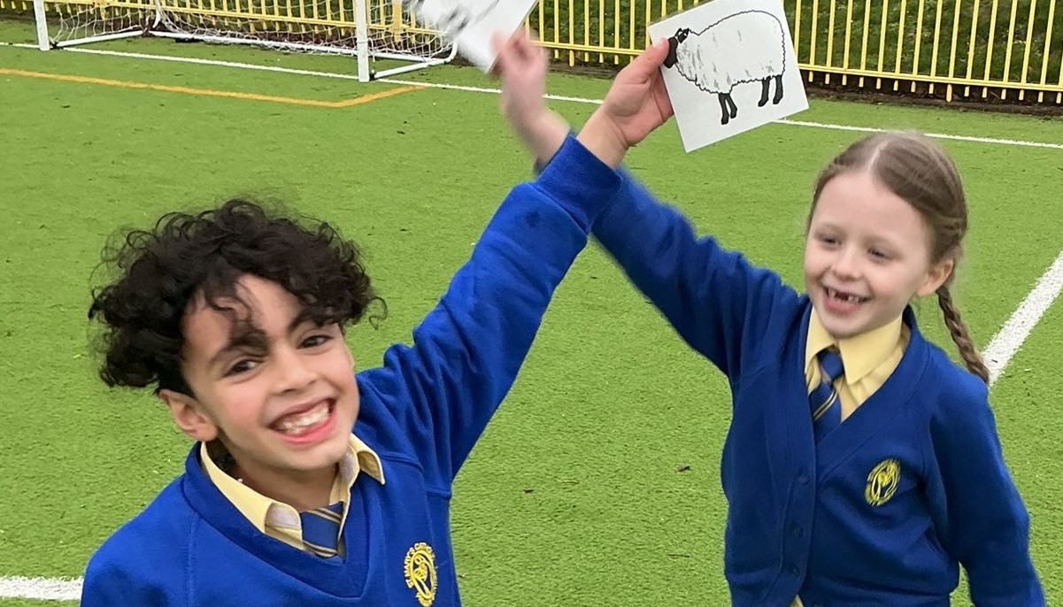 Two children holding up pictures