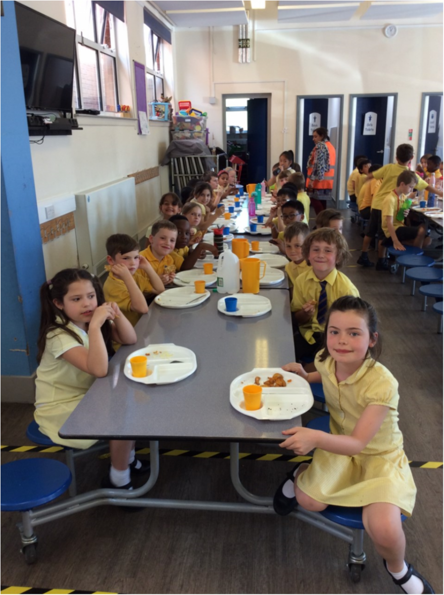 Children enjoying their hot meals in the canteen