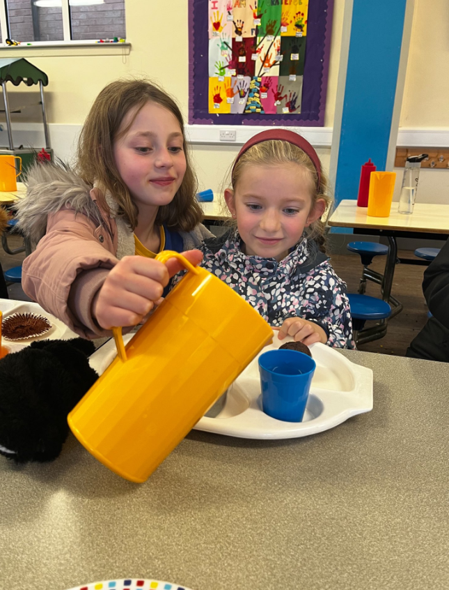 Children enjoying their hot meals in the canteen