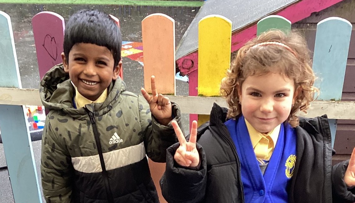 two childre making the peace sign