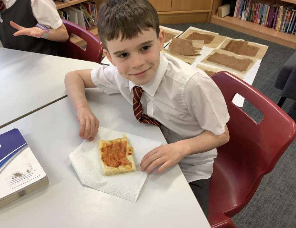 Pupil with the vegetable tart they designed in DT and baked.