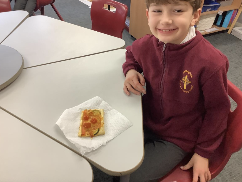 Pupil with the vegetable tart they designed in DT and baked.