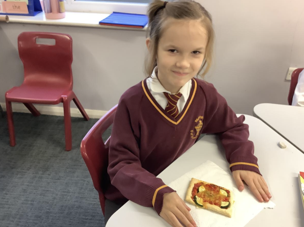 Pupil with the vegetable tart they designed in DT and baked.