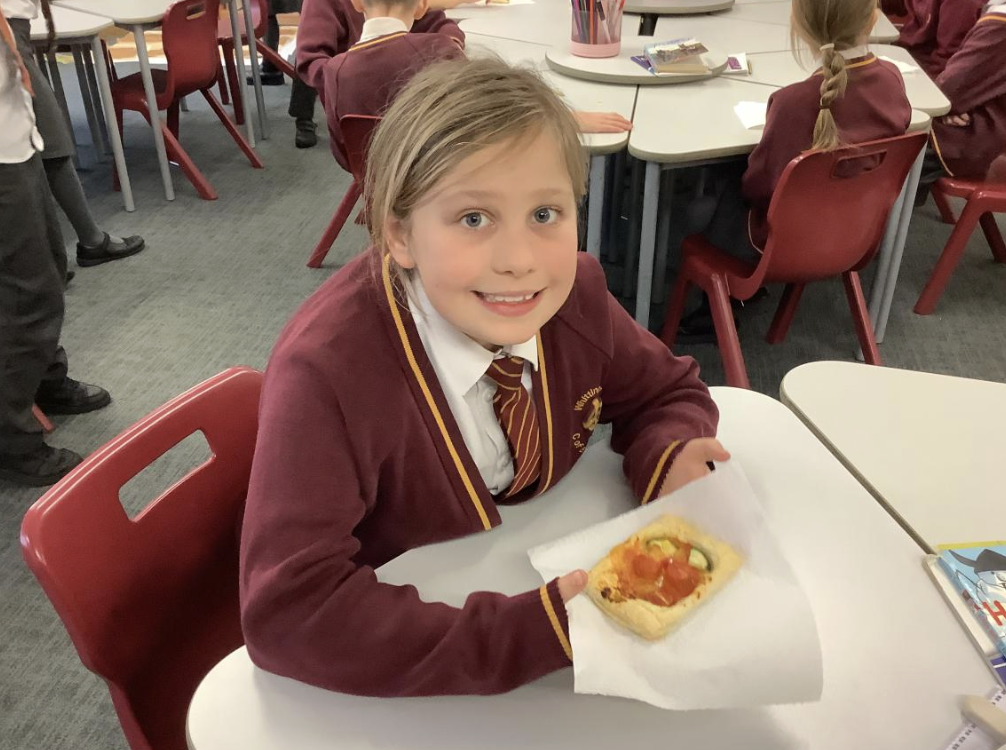 Pupil with the vegetable tart they designed in DT and baked.