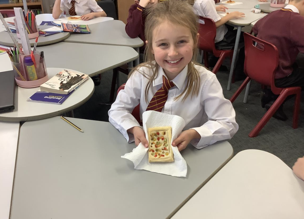 Pupil with the vegetable tart they designed in DT and baked.