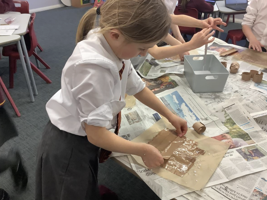 Pupil making papyrus style paper