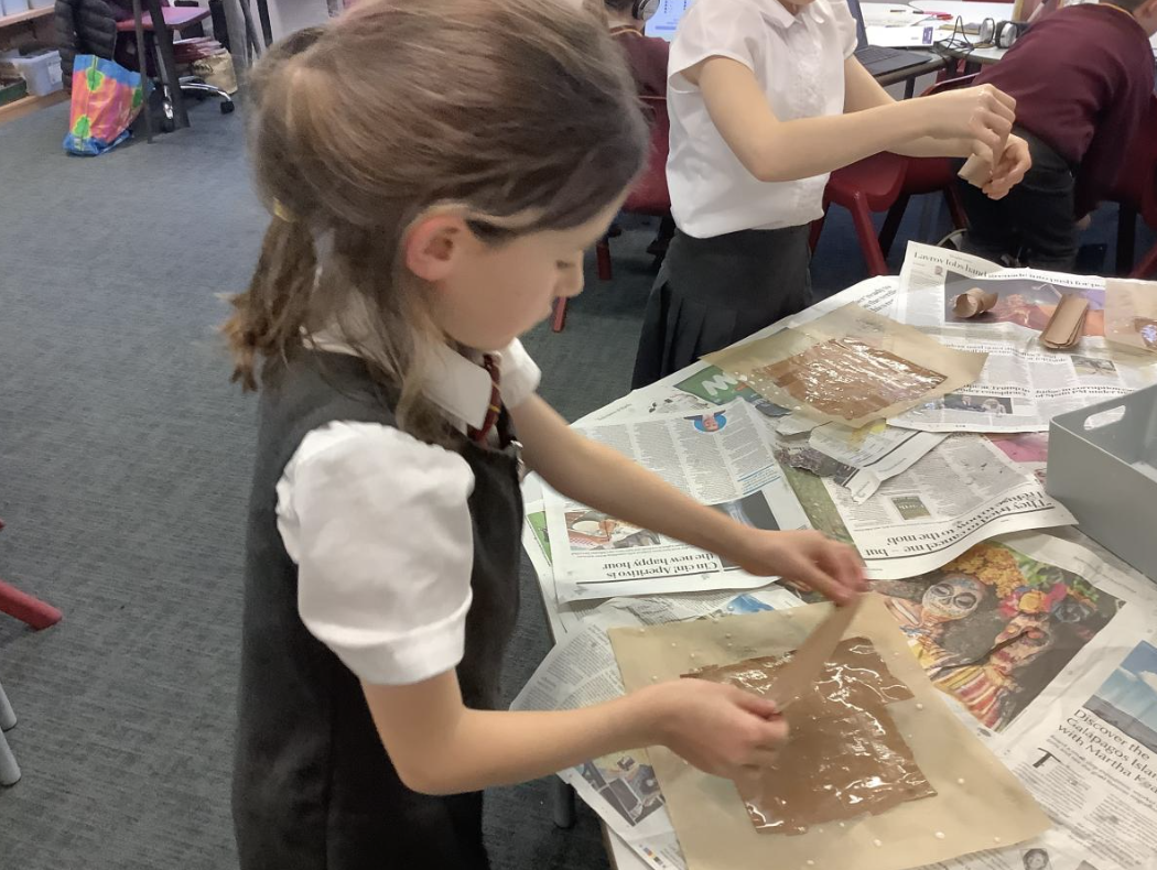 Pupil making papyrus style paper
