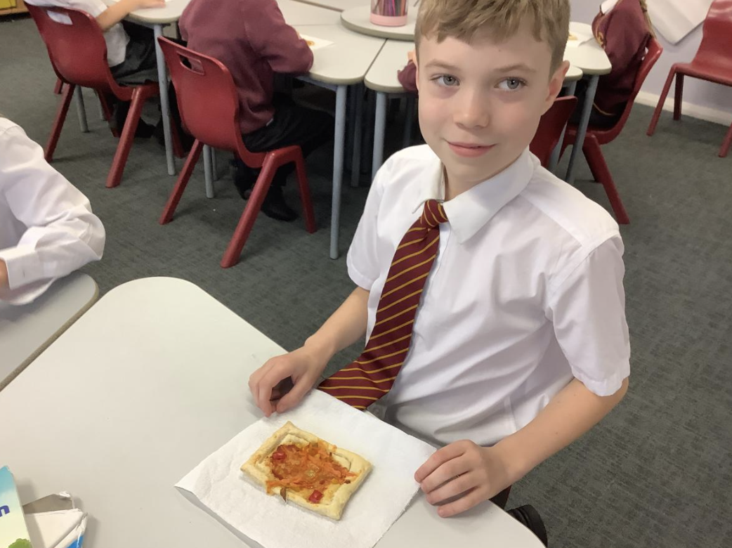 Pupil with the vegetable tart they designed in DT and baked.