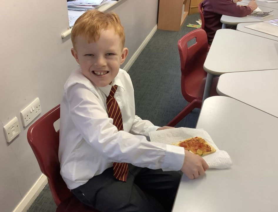Pupil with the vegetable tart they designed in DT and baked.