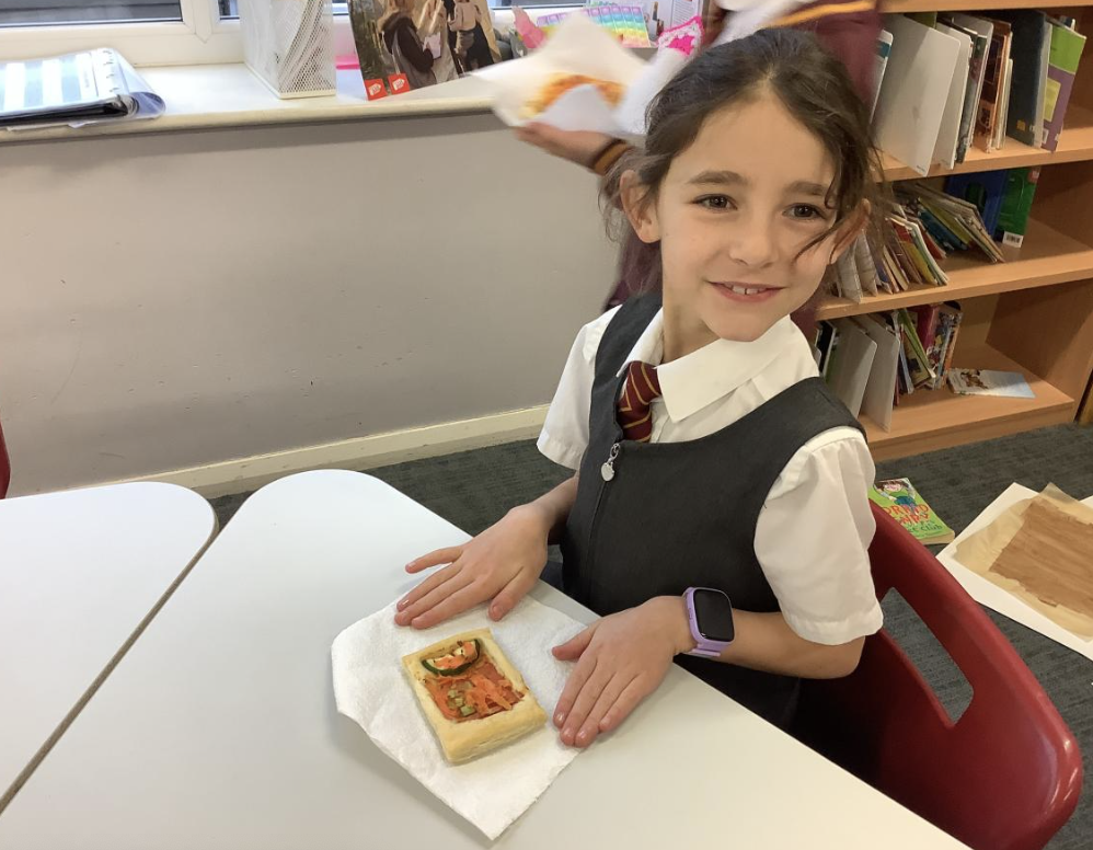 Pupil with the vegetable tart they designed in DT and baked.