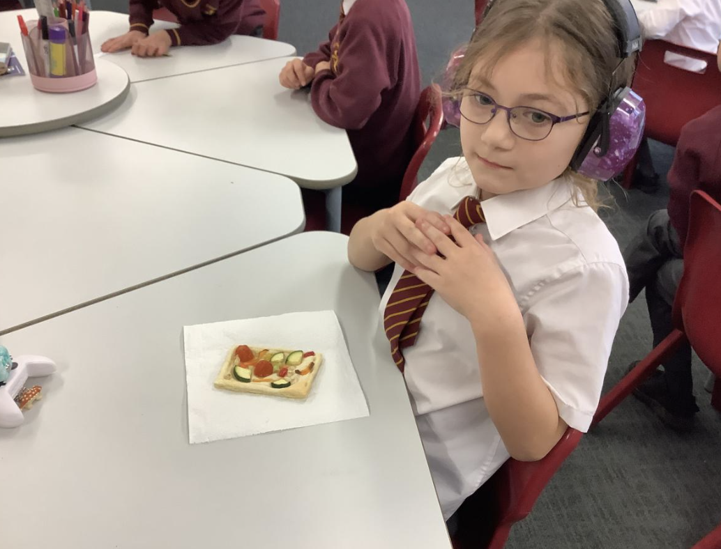 Pupil with their vegetable tart