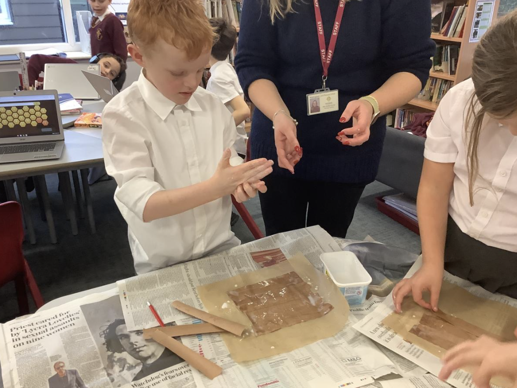 Pupil making papyrus style paper