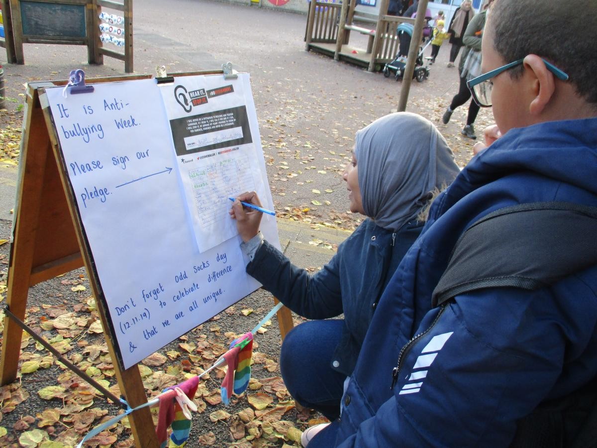 Parents, carers and children signing our No Bystanders Pledge in Anti Bullying Week. 