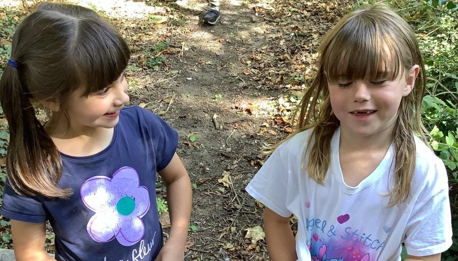 Two children stood next to each other outdoors