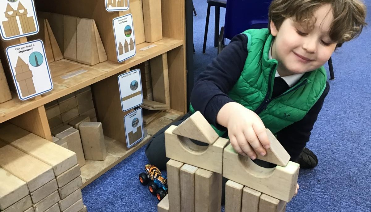 Child building with wooden blocks