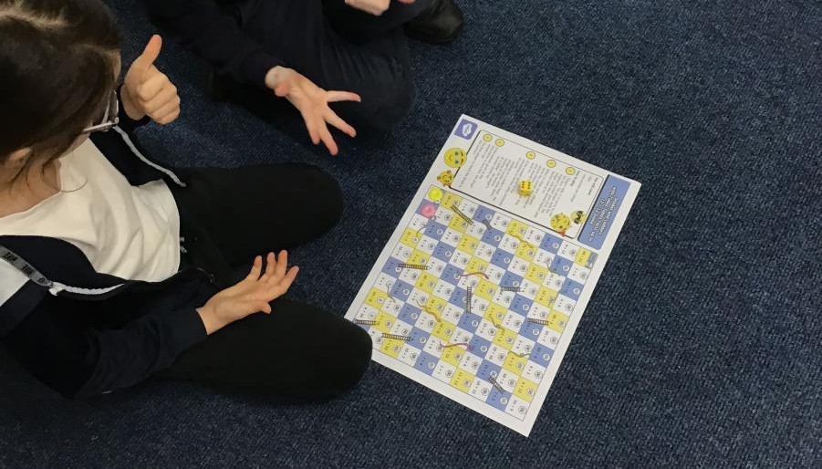 Two children sat engaged in maths activity