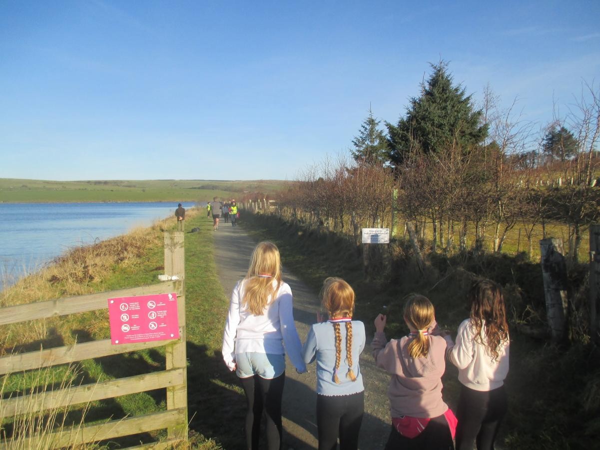 The children cheered on their friends after they had received their own medals.
