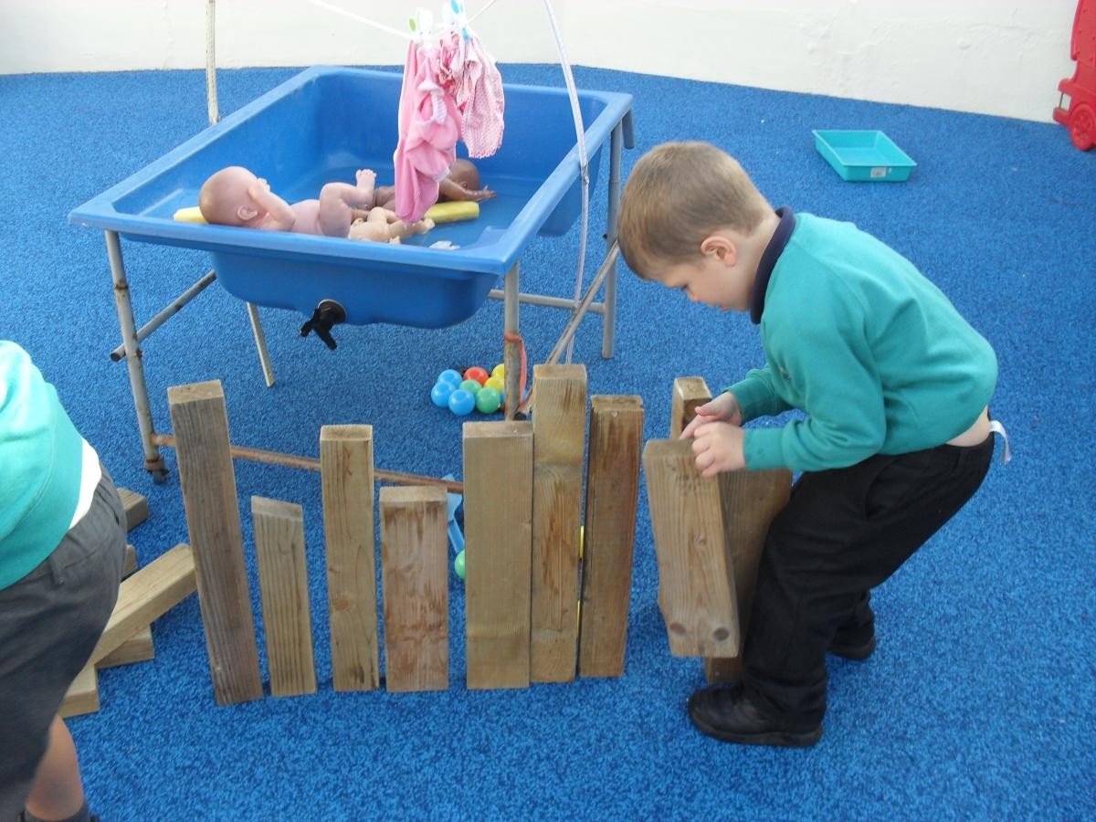 Using wooden blocks to make a wall.