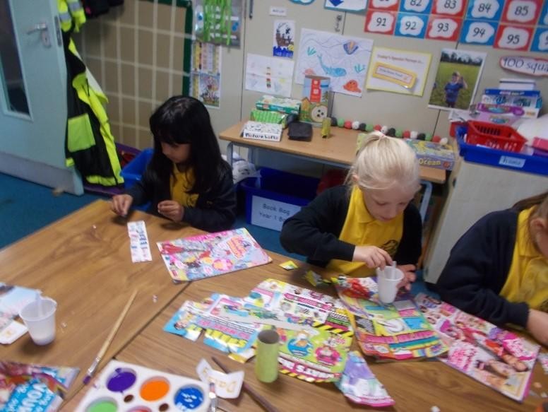 KS1 children making beach huts using toilet rolls, reclaimed cardboard (from cereal boxes) and magazines 