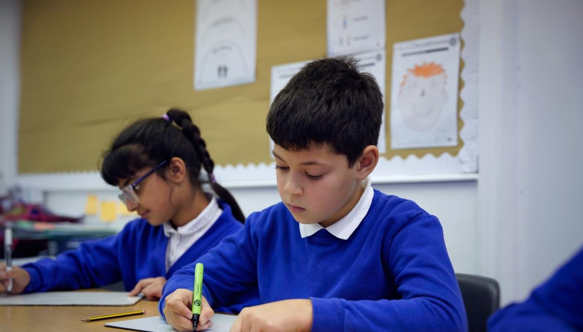 Two children writing