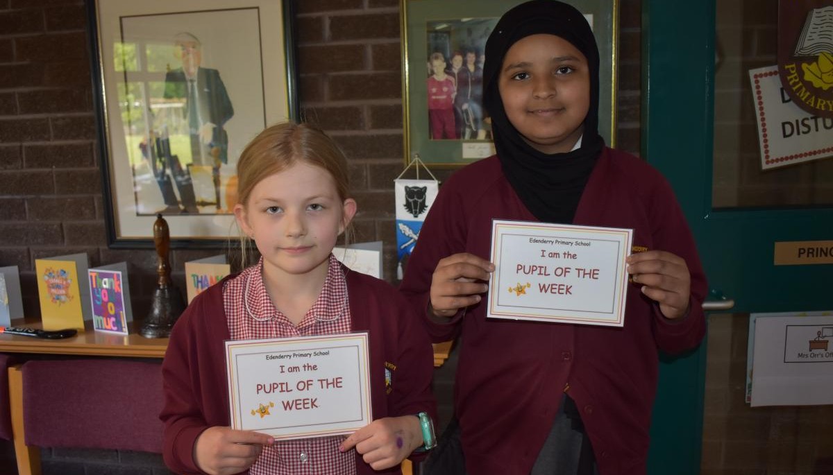 Children holding Pupil of the week certificate 