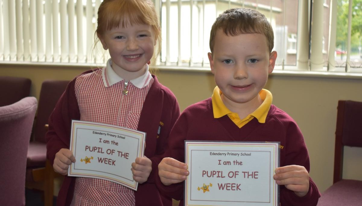 Children holding Pupil of the week certificate 