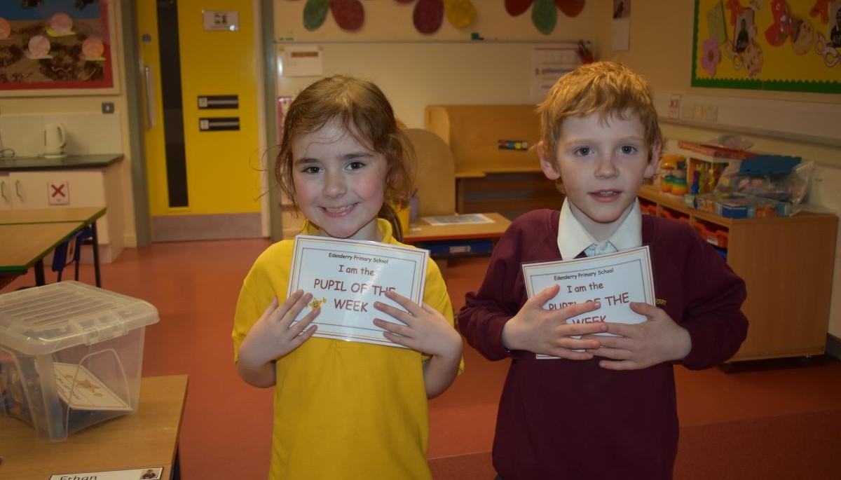 Children holding Pupil of the week certificate 