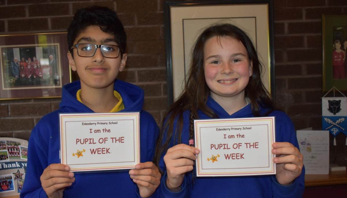 Children holding Pupil of the week certificate 
