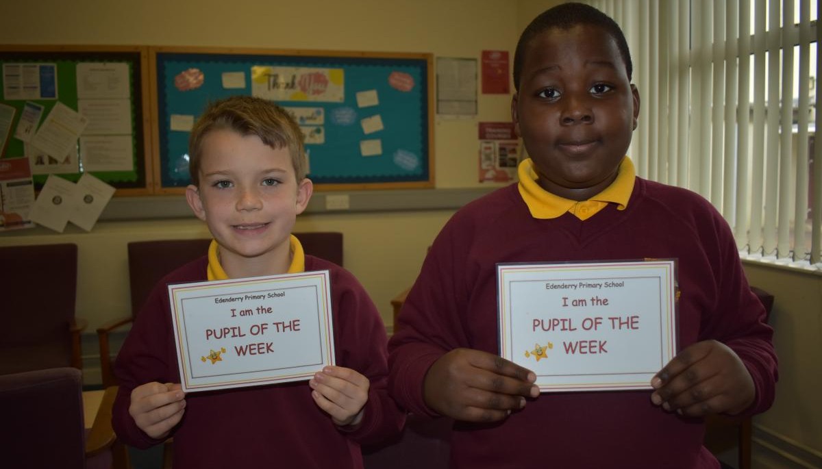 Children holding Pupil of the week certificate 