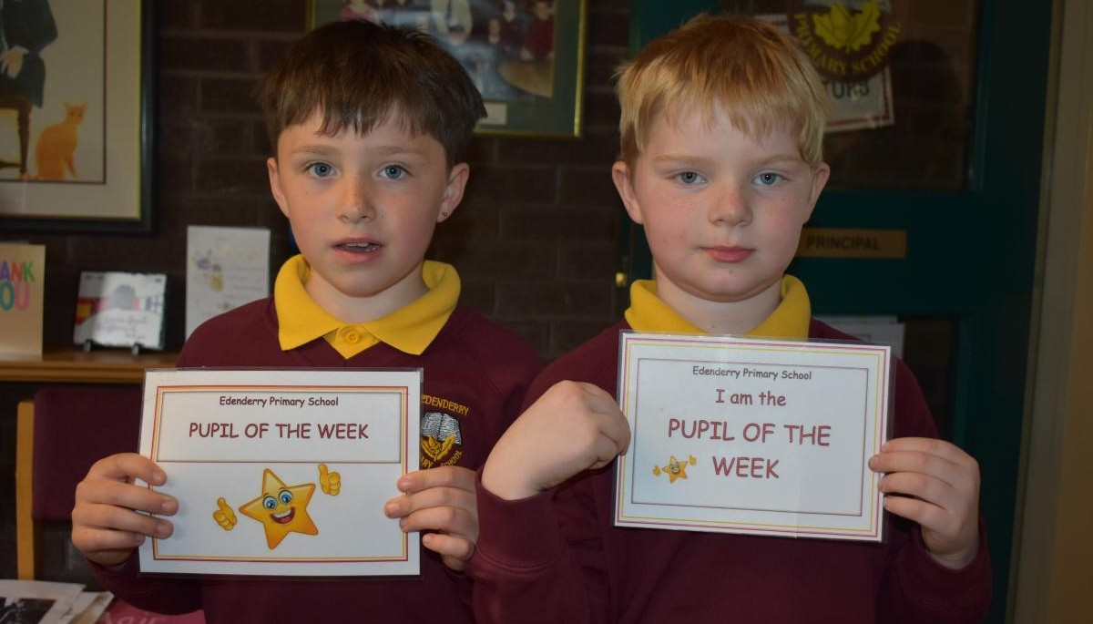 Children holding Pupil of the week certificate 