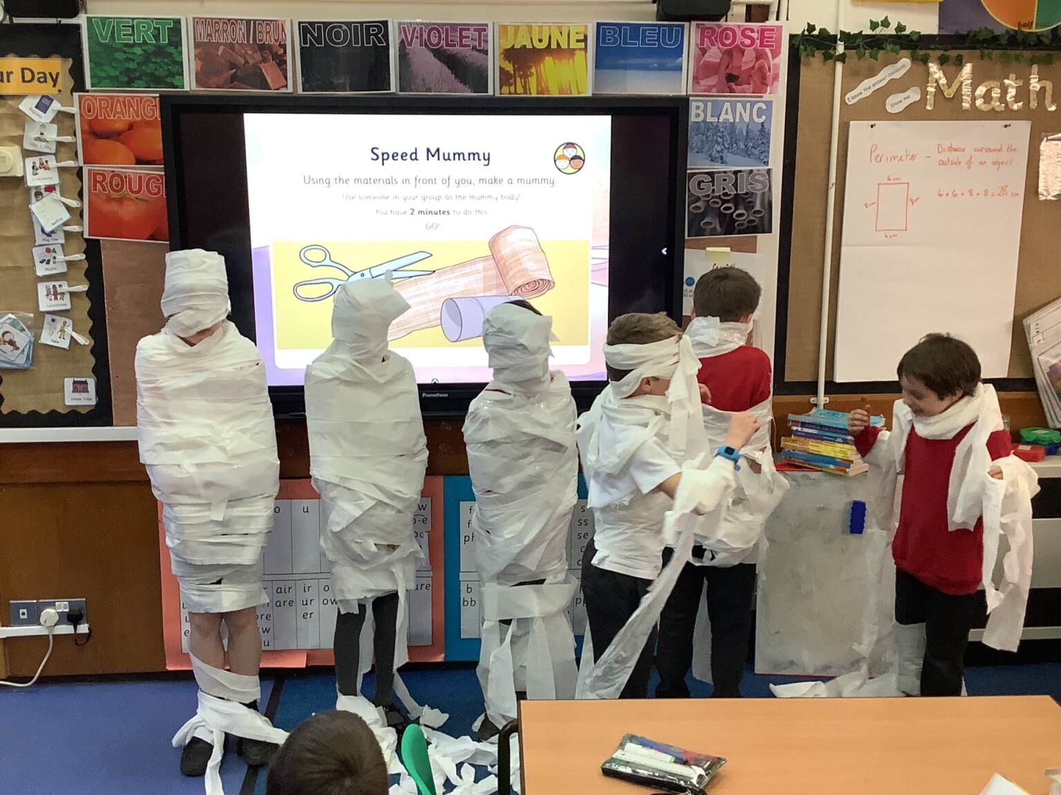 Pupils wrapping others in paper - like Mummies