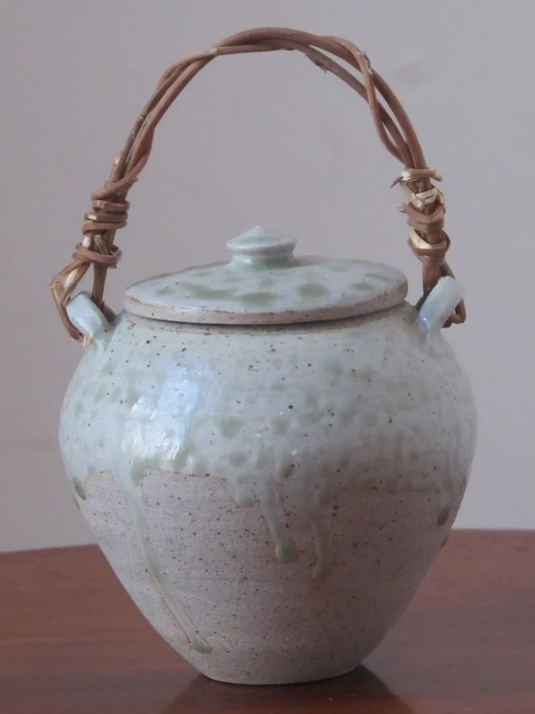 Lidded pot with wisteria handle, wood ash glaze. Sonia Lewis. 12cm W x 21cm H. £70