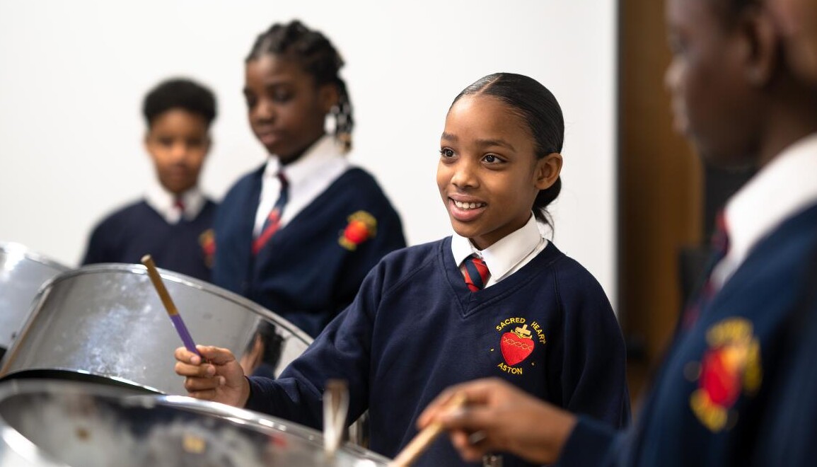 Smiling pupils playing music