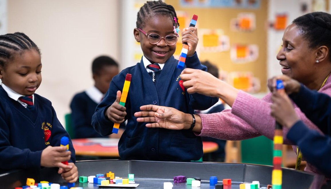 Smiling pupils using blocks