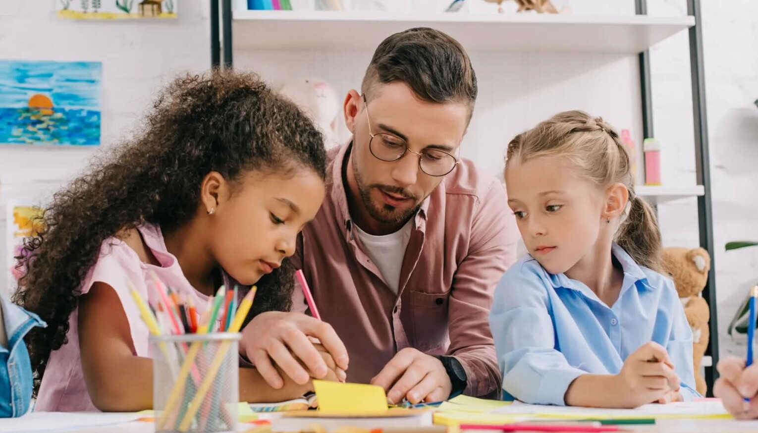 Teacher with 2 children in learning environment