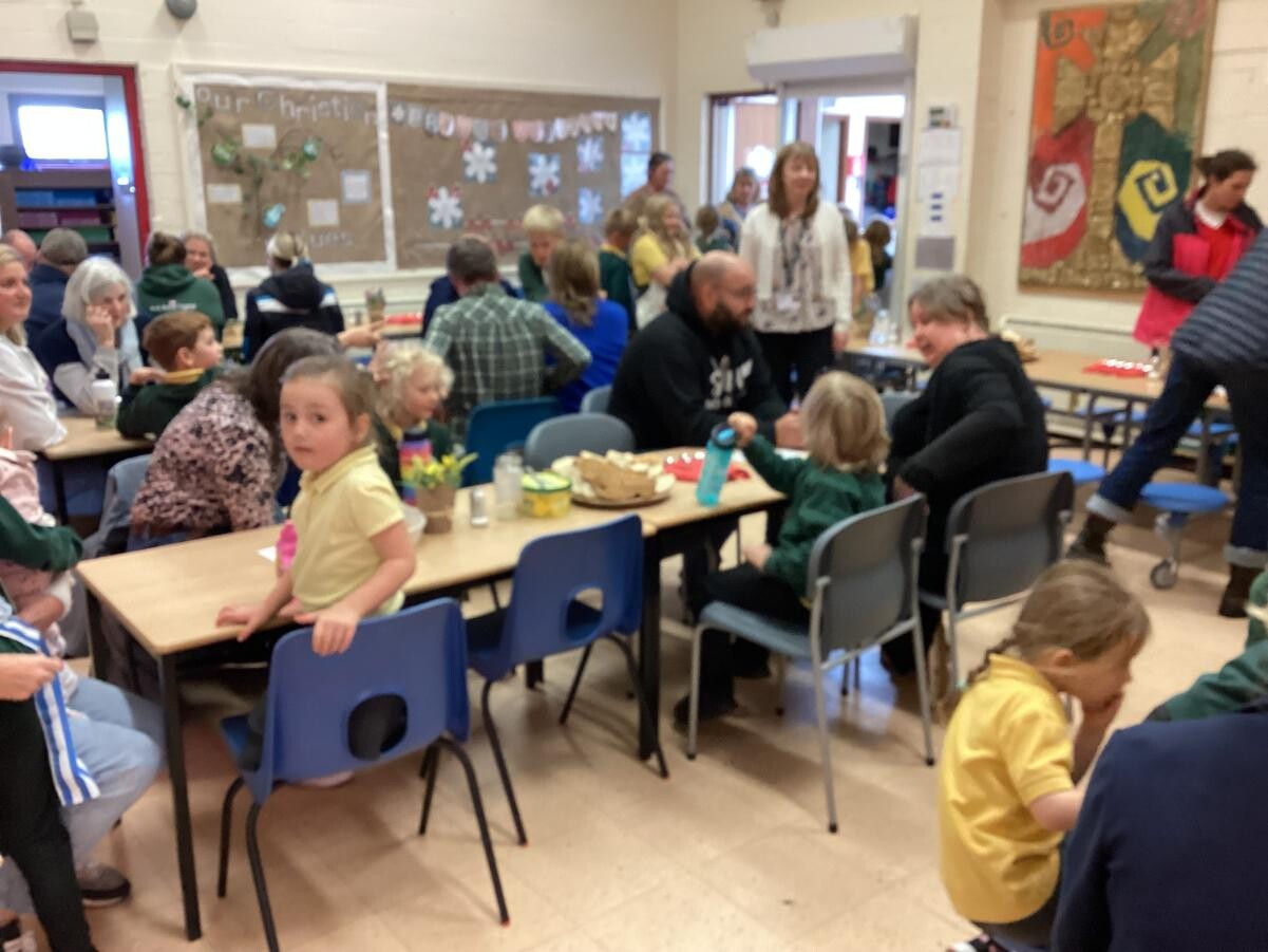 Adults and children sharing lunch together