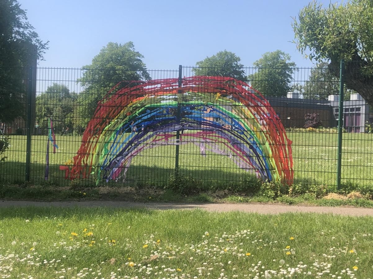 A rainbow display on fence