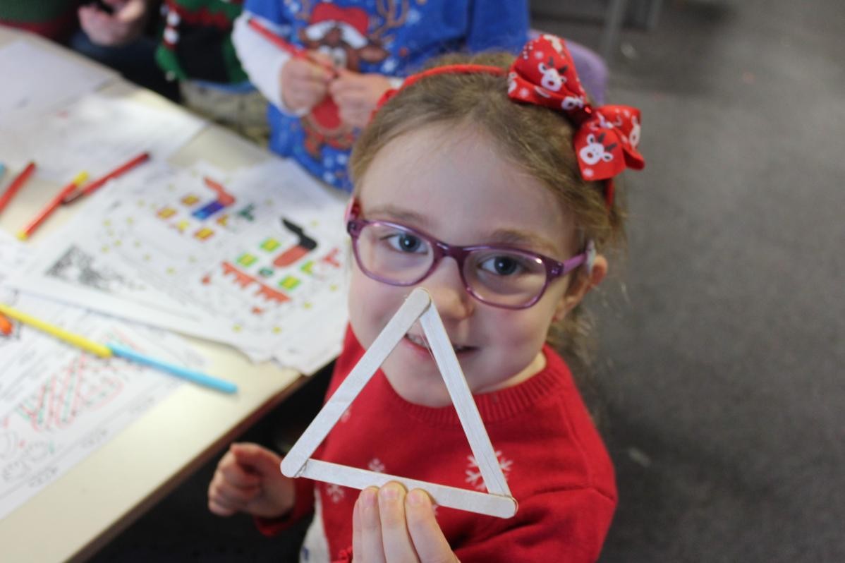 Girl showing a triangle