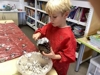 Making bird feeders using intructions the children had written during 'Book Club' 