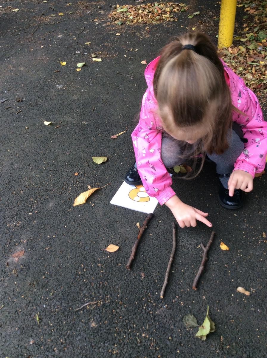 Child pointing at a stick