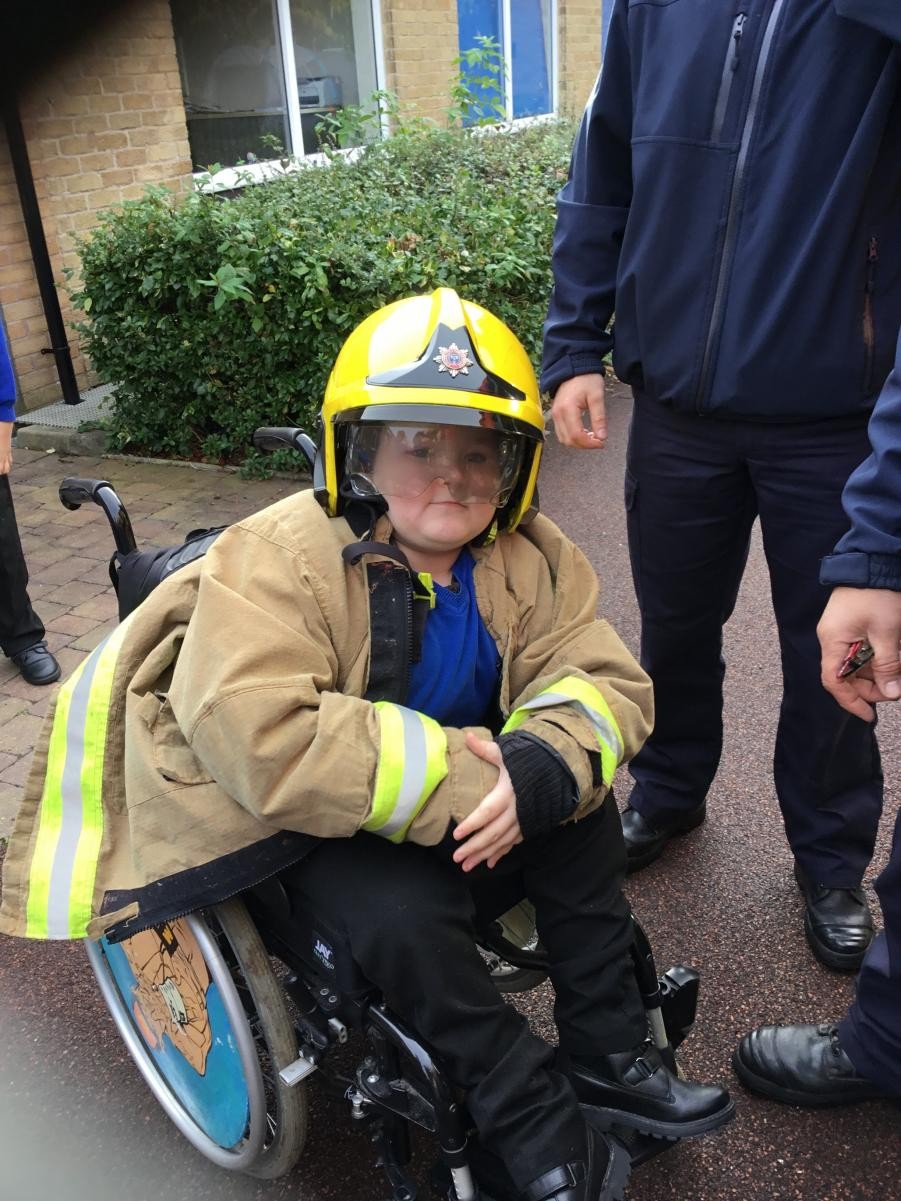 Children dressed up in firepersons uniform 