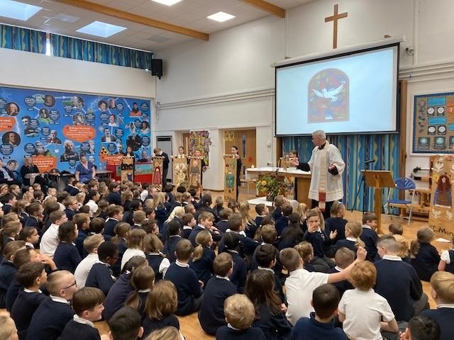 Father Paul leads the school in worship